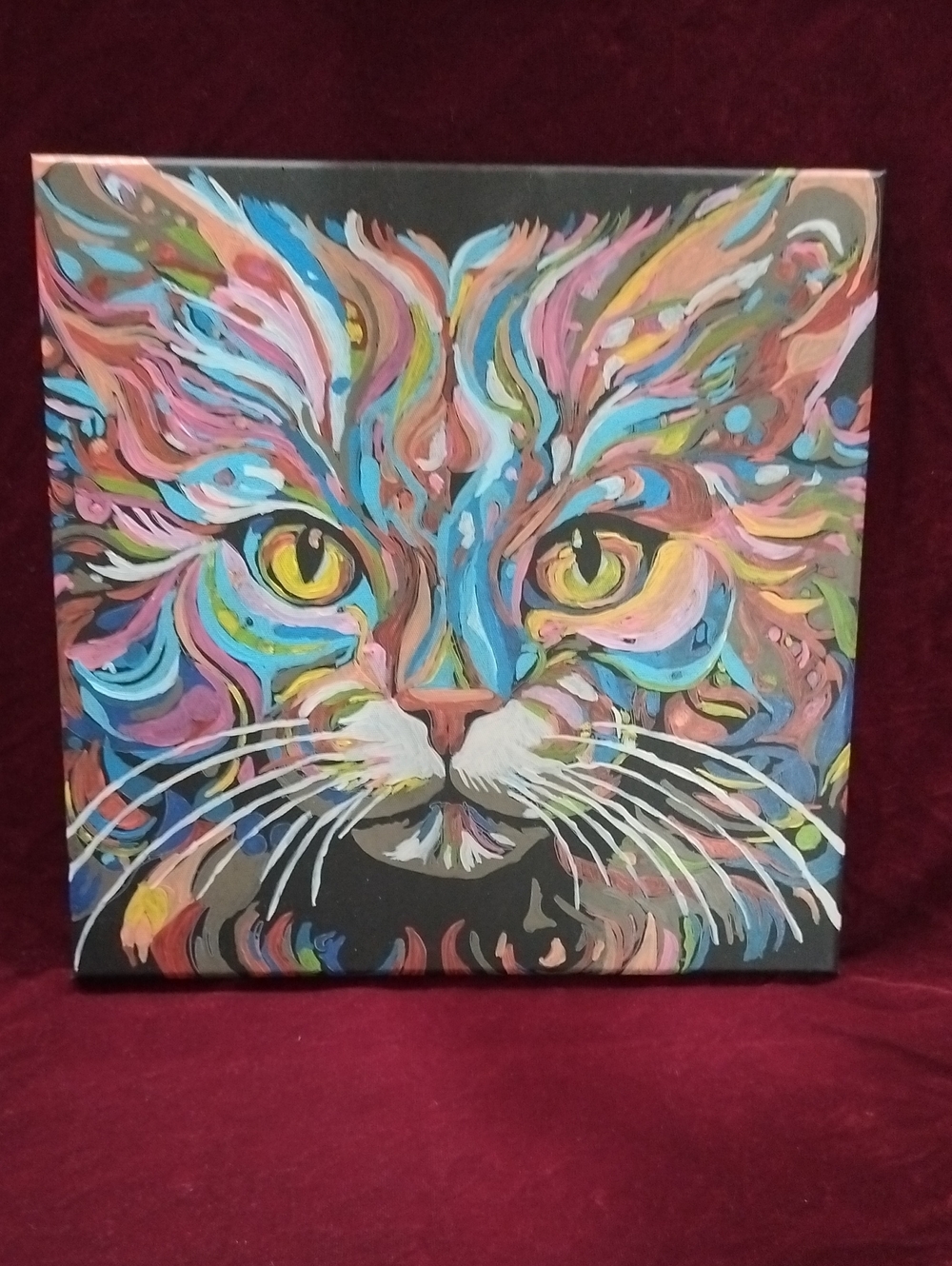 Colorful, vibrant portrait painting of a long-haired cat,